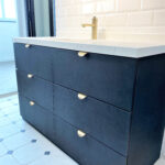 black vanity cabient with marble table top