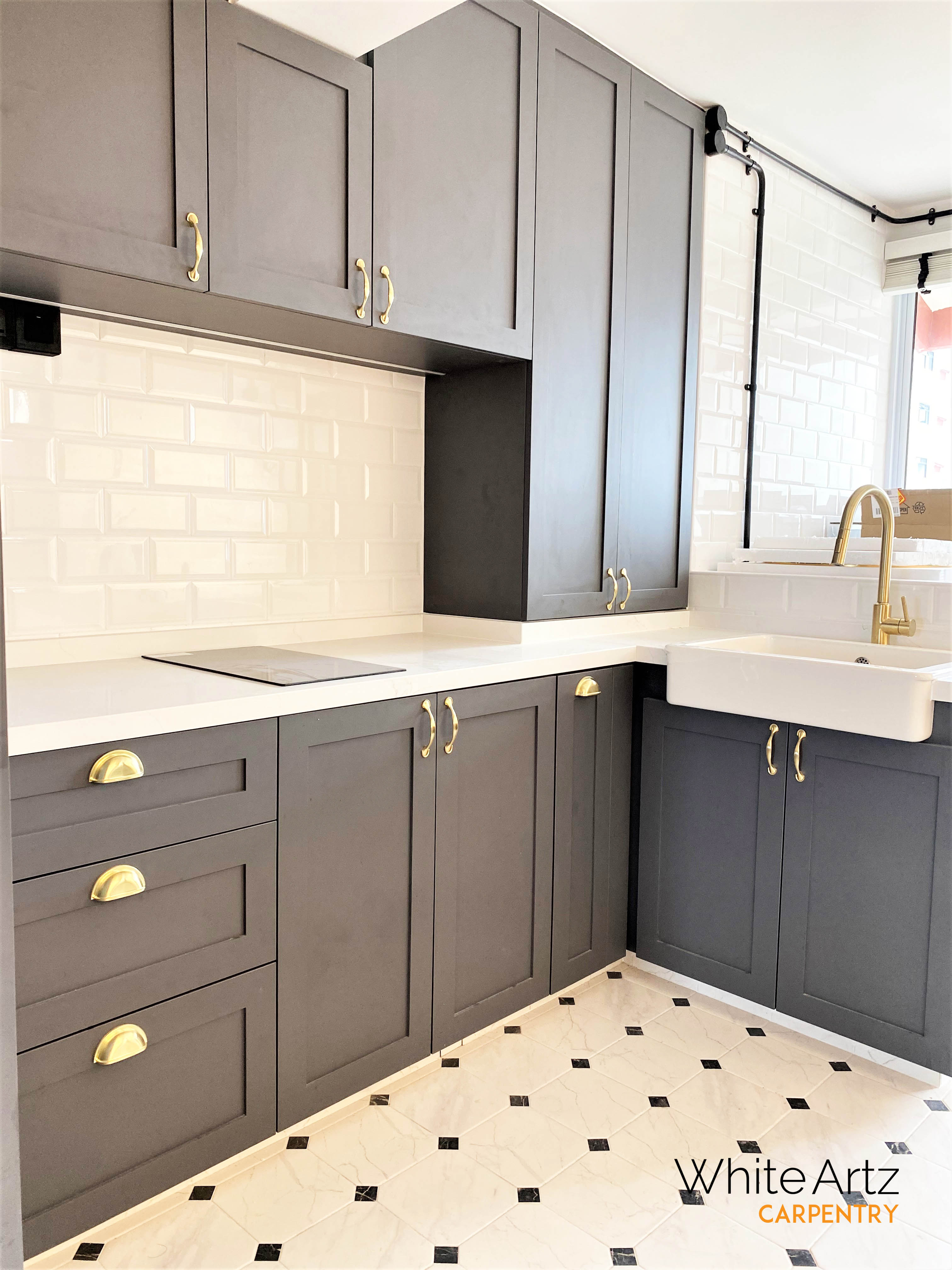 Custom dark gray Shaker kitchen cabinets by White Artz Carpentry, featuring white quartz countertop, farmhouse sink, and polished brass cup pulls.