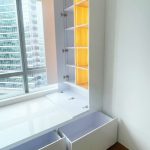 Custom bay window platform with open storage drawers and lighted bookshelf by direct carpenter Singapore