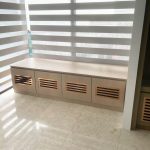 Custom low storage bench cabinet with slatted wooden doors by direct carpentry Singapore